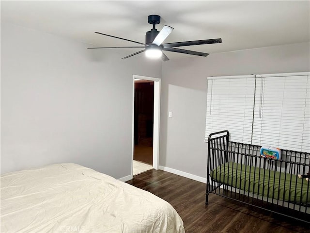 bedroom with dark wood-type flooring and ceiling fan