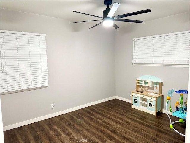 rec room with ceiling fan and dark hardwood / wood-style floors