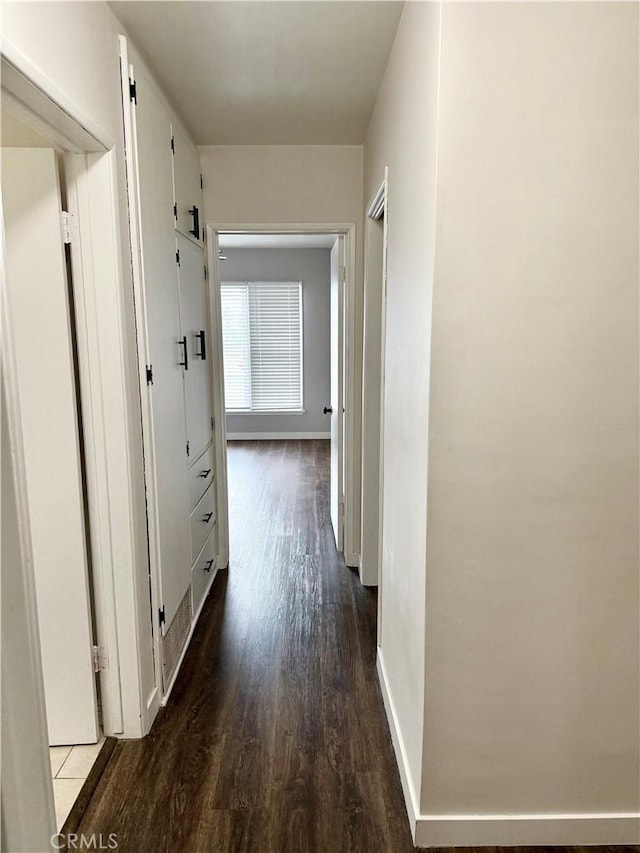 corridor featuring dark hardwood / wood-style flooring