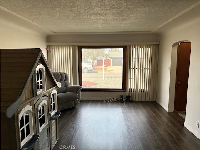 unfurnished room with a textured ceiling and dark hardwood / wood-style flooring