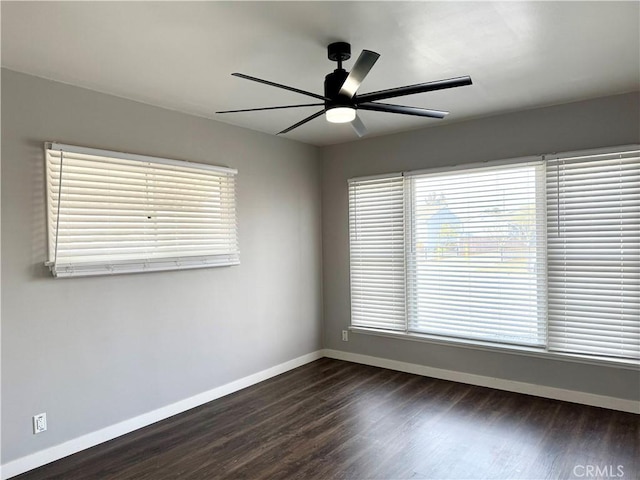 empty room with dark hardwood / wood-style flooring and ceiling fan