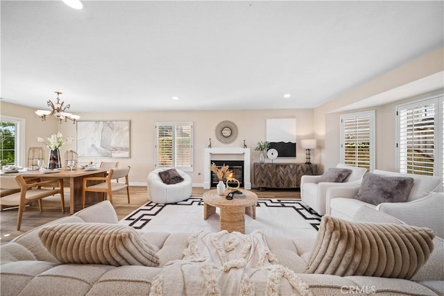 living room with a chandelier and light hardwood / wood-style floors