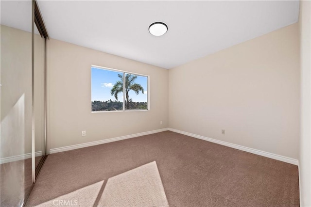 unfurnished bedroom featuring a closet and carpet flooring