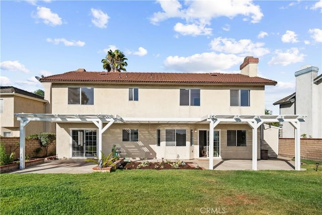 back of house with a pergola, a patio area, and a yard