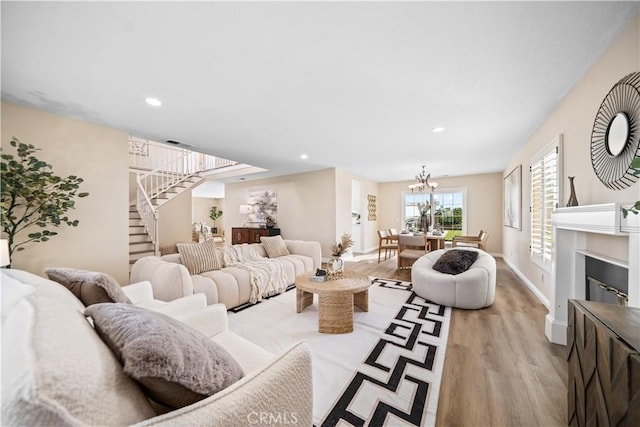 living room featuring a notable chandelier and light hardwood / wood-style flooring