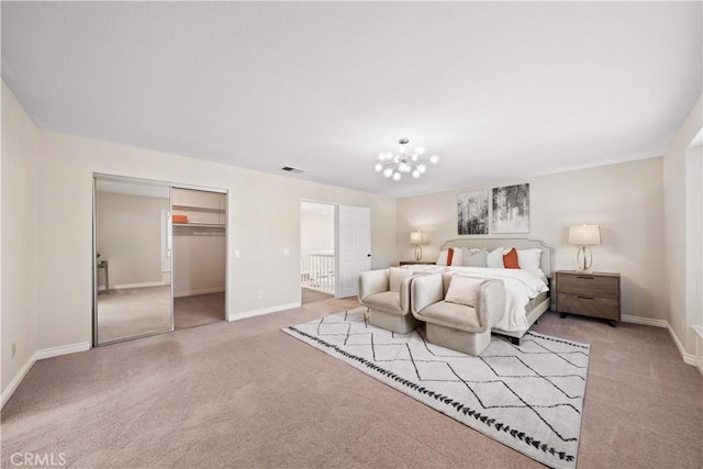 bedroom featuring a closet, light colored carpet, and a notable chandelier