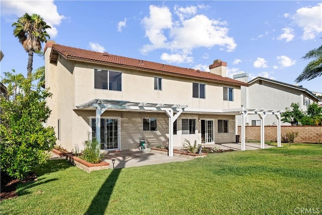 back of property featuring a patio, a lawn, and a pergola