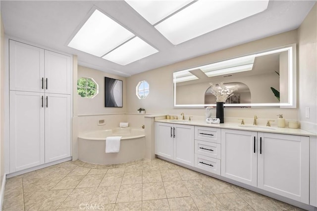 bathroom with a washtub, tile patterned floors, vanity, and a notable chandelier