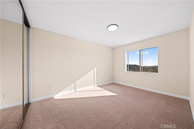 unfurnished room featuring carpet flooring