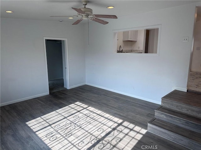 unfurnished room featuring ceiling fan and dark hardwood / wood-style flooring