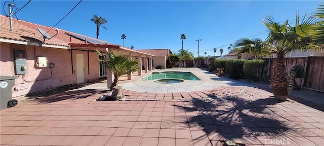 view of swimming pool featuring a patio area and an in ground hot tub