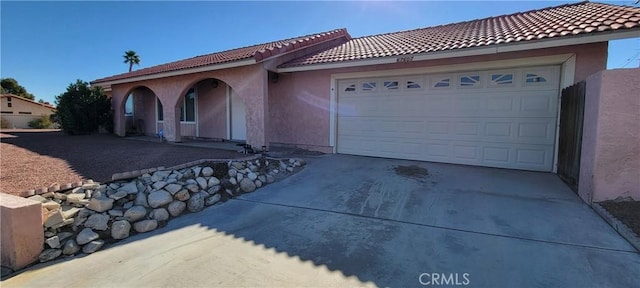 mediterranean / spanish-style house with a garage