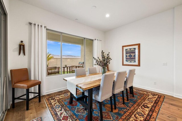 dining space with hardwood / wood-style floors