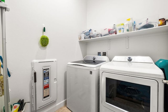 laundry room featuring light tile patterned floors and washer and clothes dryer