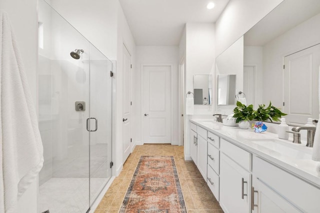 bathroom featuring vanity and a shower with door