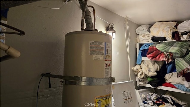 utility room featuring water heater