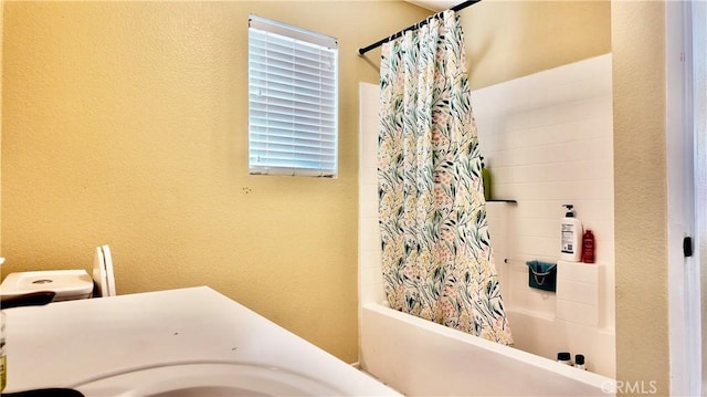 bathroom featuring shower / bath combination with curtain