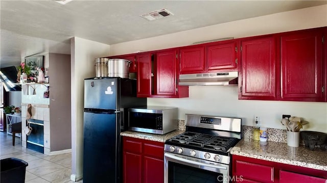 kitchen featuring light tile patterned floors and appliances with stainless steel finishes