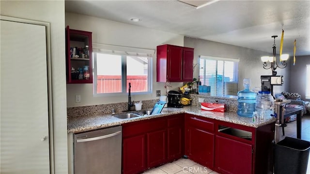 kitchen featuring dishwasher, a notable chandelier, pendant lighting, light tile patterned flooring, and sink