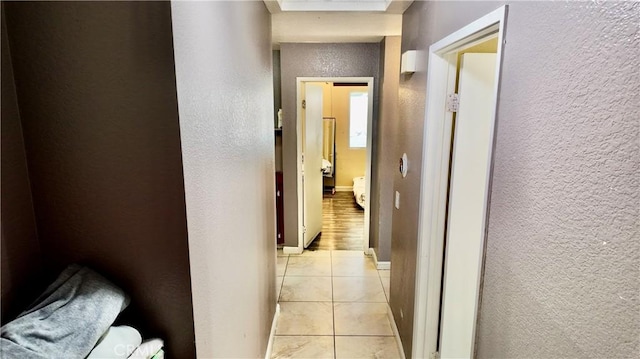 hall featuring light tile patterned floors