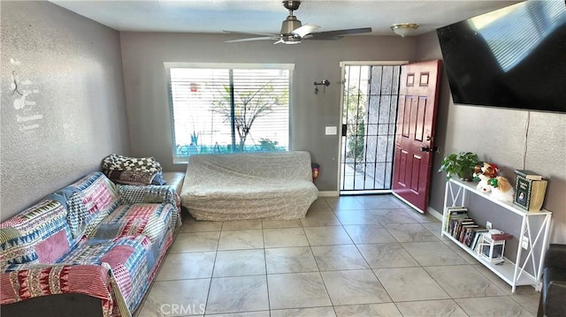 interior space with ceiling fan