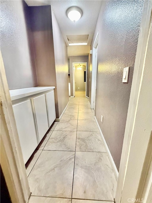11807 Lupin Rd, Adelanto, CA 92301 - hallway with baseboards and light marble finish flooring