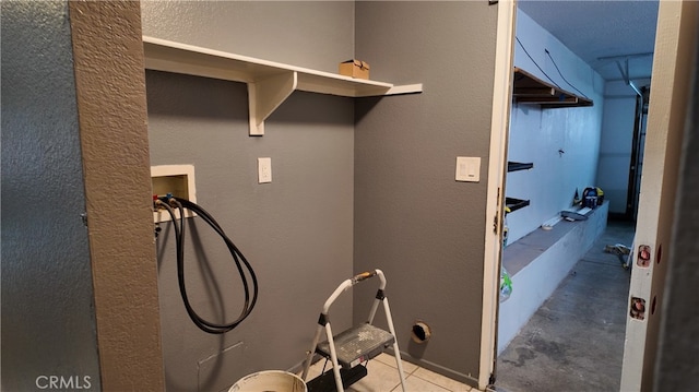 11807 Lupin Rd, Adelanto, CA 92301 - laundry room with washer hookup and a textured wall