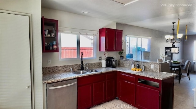 11807 Lupin Rd, Adelanto, CA 92301 - kitchen with stainless steel dishwasher, a sink, a peninsula, hanging light fixtures, and light stone counters