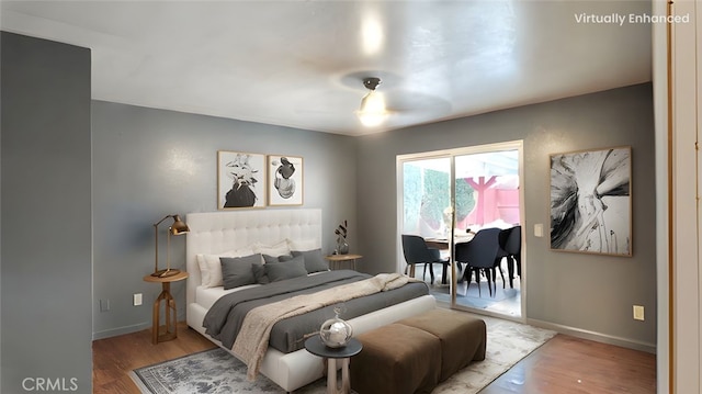 11807 Lupin Rd, Adelanto, CA 92301 - bedroom with access to exterior, wood finished floors, and baseboards