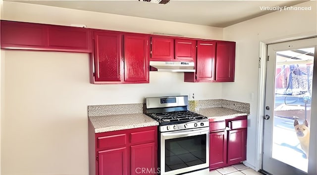 11807 Lupin Rd, Adelanto, CA 92301 - kitchen with stainless steel gas range oven, under cabinet range hood, light stone counters, and red cabinets