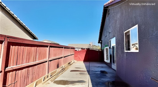 11807 Lupin Rd, Adelanto, CA 92301 - view of side of home featuring a fenced backyard, stucco siding, and a patio