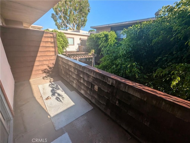 view of patio featuring a balcony