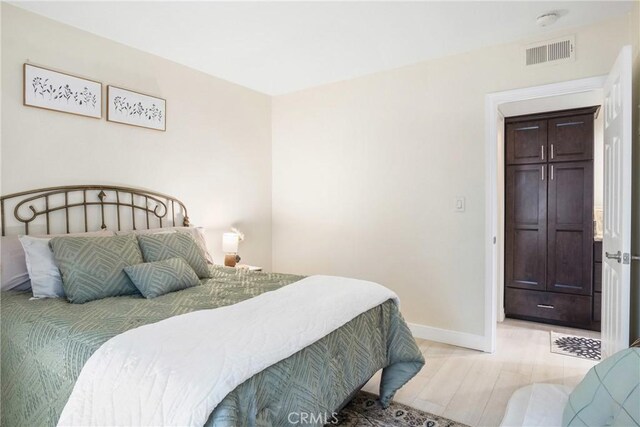 bedroom with light wood-type flooring