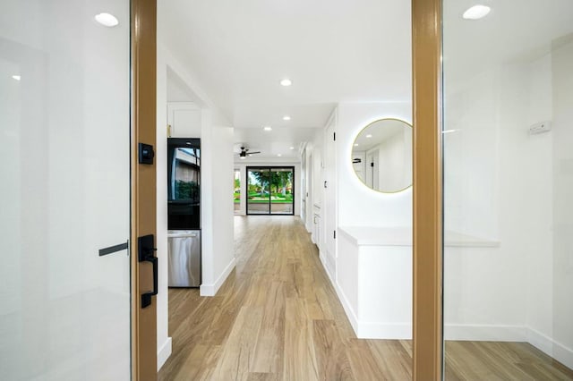 corridor with light hardwood / wood-style flooring