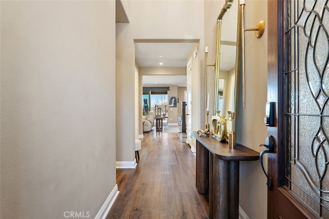 foyer entrance featuring dark wood-style flooring and baseboards