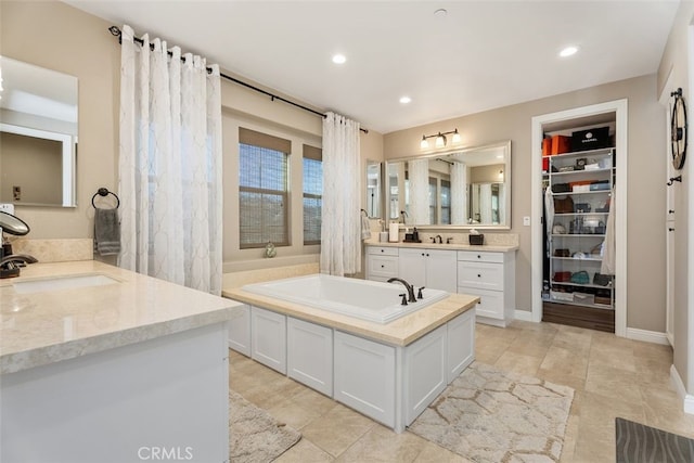 bathroom with vanity and a tub