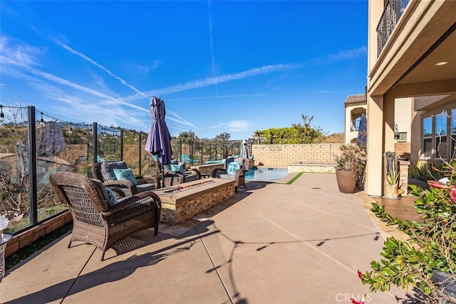 view of patio with a fenced backyard and a fire pit