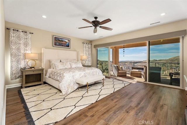 bedroom with wood-type flooring, access to outside, and ceiling fan