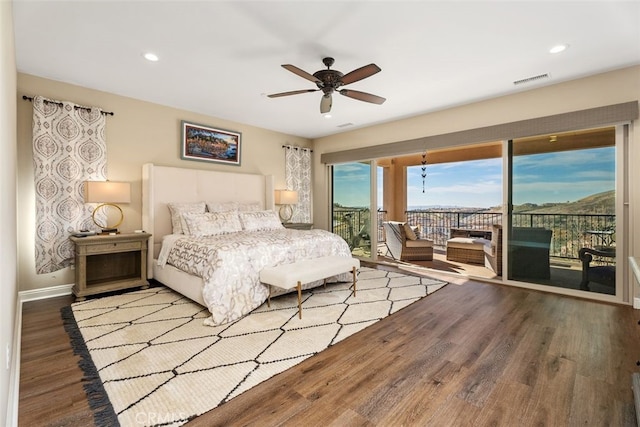 bedroom with access to exterior, recessed lighting, visible vents, wood finished floors, and baseboards