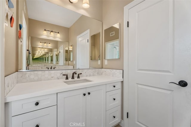 bathroom featuring tasteful backsplash and vanity