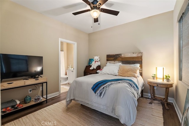 bedroom featuring hardwood / wood-style flooring, ceiling fan, and ensuite bath