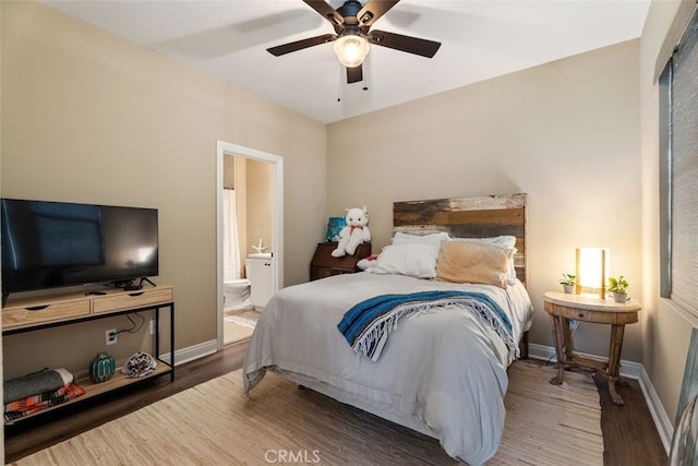 bedroom featuring ensuite bathroom, ceiling fan, wood finished floors, and baseboards