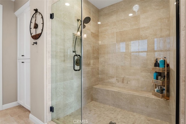 bathroom featuring a shower with door