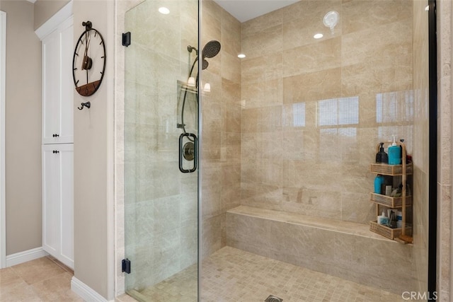 full bathroom with tile patterned flooring, a shower stall, and baseboards