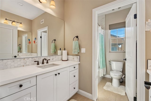 bathroom featuring vanity, backsplash, tile patterned floors, and toilet