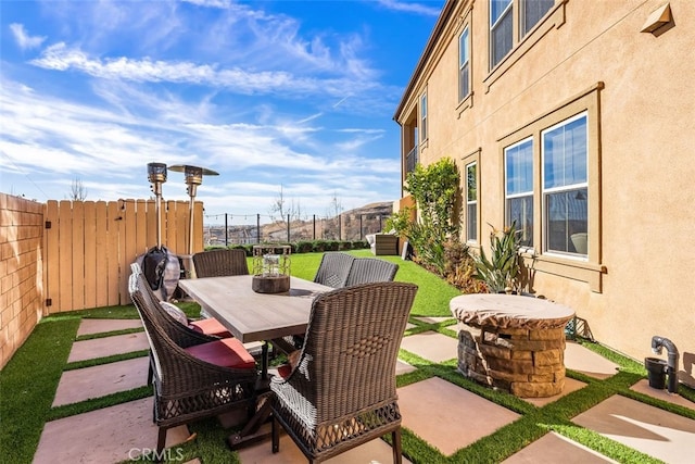 view of patio / terrace featuring fence and outdoor dining area