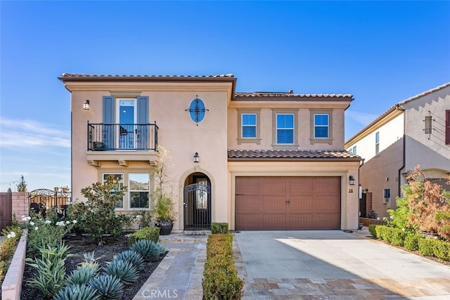 mediterranean / spanish-style house featuring a balcony and a garage