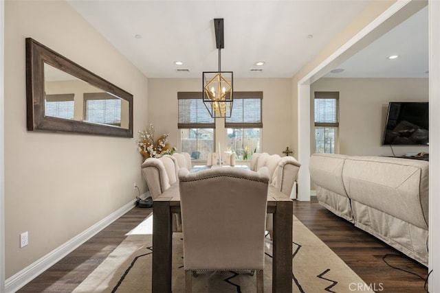 dining room featuring baseboards, dark wood-style flooring, a chandelier, and a healthy amount of sunlight