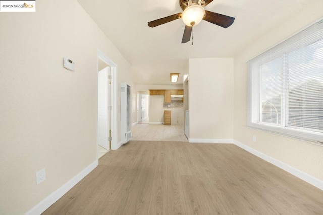 unfurnished living room featuring ceiling fan and light wood-type flooring