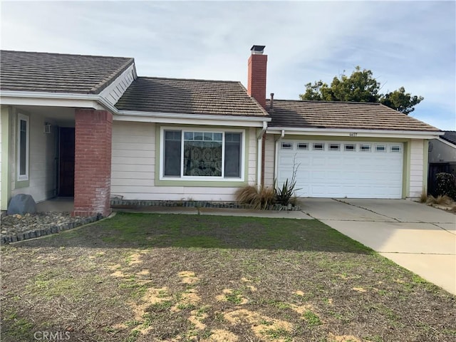 single story home with a garage and a front lawn